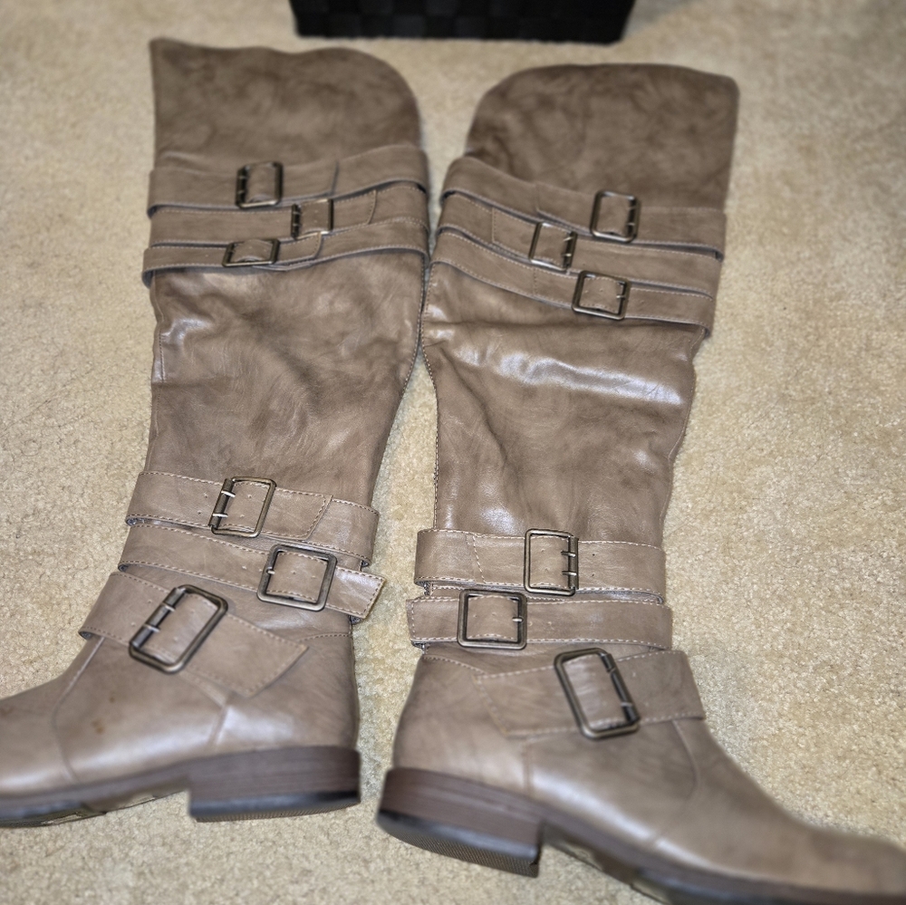 Over the knee boots that pull on with 3 fashionable straps at the ankle & calf.